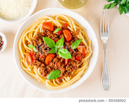 pasta bolognese with tomato sauce, ground minced beef, basil leaves on background pasta bolognese with tomato sauce, ground minced beef, basil leaves on background 89388002