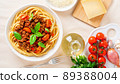 pasta bolognese with tomato sauce, ground minced beef, basil leaves on background 89388004
