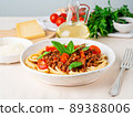 pasta bolognese with tomato sauce, ground minced beef, basil leaves on background 89388006