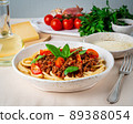 pasta bolognese with tomato sauce, ground minced beef, basil leaves on background 89388054