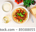 pasta bolognese with tomato sauce, ground minced beef, basil leaves on background 89388055
