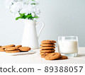 Chocolate oatmeal cookies and milk in glass, healthy snack. Light background, grey light wall 89388057