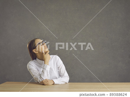 Serious woman looking up thinking, thoughtful woman in white shirt confident, copy space. Serious woman looking up thinking, thoughtful woman in white shirt confident, copy space. 89388624