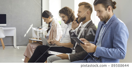 Group of people sitting in line waiting for job interview or business appointment 89388644