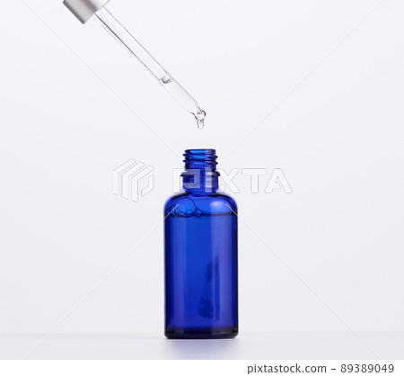 blue glass bottle with pipette for cosmetics, oils and serum. Advertising and product promotion 89389049