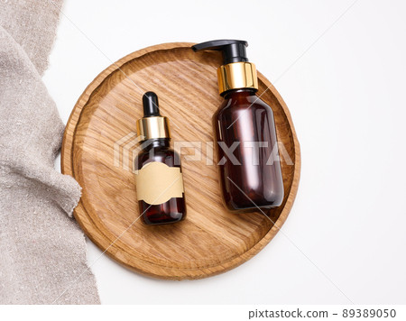 brown glass bottle with pipette for cosmetics, oils and serum. Paper blank label pasted 89389050