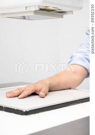 Man in x-ray room having medical scan examination in a modern hospital. Man in x-ray room having medical scan examination in a modern hospital. 89392330