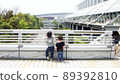 The back view of two children counting the cars running on the road from the top to the bottom of Makuhari Park Mall visited at the event is cute 89392810