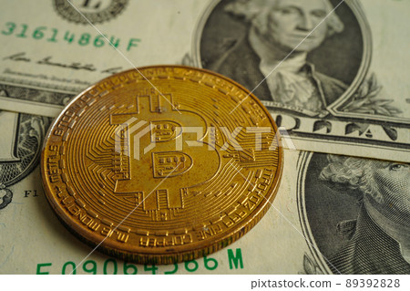Golden bitcoin on US dollar banknotes money for business and commercial, Digital currency, Virtual cryptocurrency, blockchain technology. Golden bitcoin on US dollar banknotes money for business and commercial, Digital currency, Virtual cryptocurrency, blockchain technology. 89392828