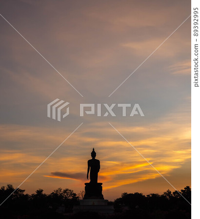 Silhouette technique under golden twilight evening sky with Walking Buddha statue in Thailand Silhouette technique under golden twilight evening sky with Walking Buddha statue in Thailand 89392995