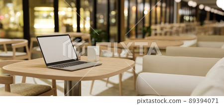 Comfortable restaurant or coffee shop seating area interior design with laptop mockup Comfortable restaurant or coffee shop seating area interior design with laptop mockup 89394071