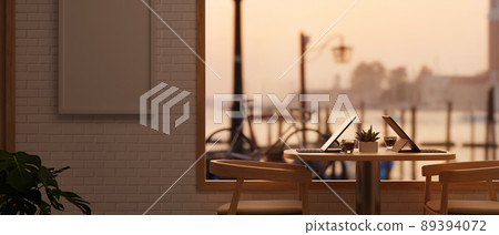 Comfortable restaurant or coffee shop interior seating area near window with the evening sunlight. 89394072