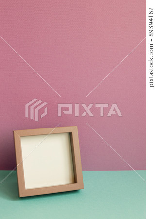 Blank picture frame on mint green table. pink wall background. copy space Blank picture frame on mint green table. pink wall background. copy space 89394162
