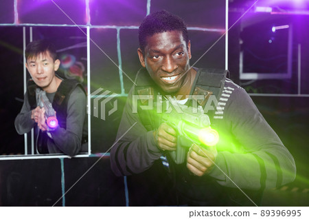 Portrait of cheerful African-American with laser gun having fun 89396995