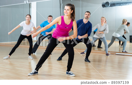 Woman training at group dance class Woman training at group dance class 89397139
