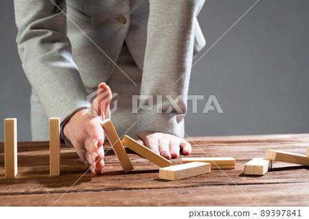 Business woman hand block domino effect 89397841