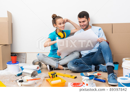 Young man and woman planning home renovation Young man and woman planning home renovation 89397842