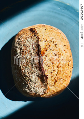 Homemade wheat bread with flax seeds. The concept of homemade bread and healthy food. Top view. Flat lay. Homemade wheat bread with flax seeds. The concept of homemade bread and healthy food. Top view. Flat lay. 89398497