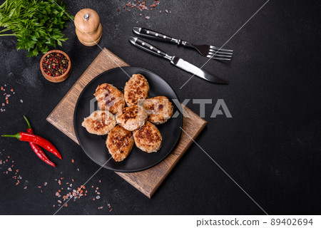 Delicious fresh fried minced meat patties on a dark concrete background Delicious fresh fried minced meat patties on a dark concrete background 89402694