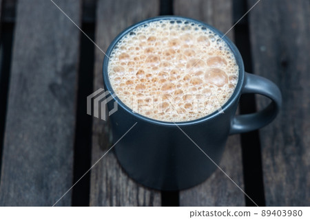 Teh Tarik, is infused black tea with milk served in thick froth. Popular drinks in Malaysia Teh Tarik, is infused black tea with milk served in thick froth. Popular drinks in Malaysia 89403980