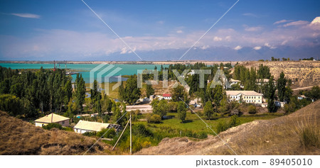aerial panorama view to Karakol towm, formerly Przhevalsk, and Issyk-Kul lake, Kyrgyzstan 89405010