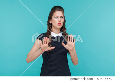 Fear or nightmare concept. Shocked beautiful woman looking at camera. Indoor, studio shot on blue background Fear or nightmare concept. Shocked beautiful woman looking at camera. Indoor, studio shot on blue background 89405369