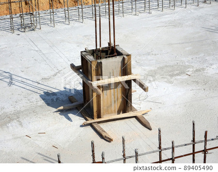 SELANGOR, MALAYSIA -JULY 7, 2021: Column stump formwork that has been installed at the construction site. Steel reinforcement bars are ready to be installed and ready to be poured concrete into it. SELANGOR, MALAYSIA -JULY 7, 2021: Column stump formwork that has been installed at the construction site. Steel reinforcement bars are ready to be installed and ready to be poured concrete into it. 89405490