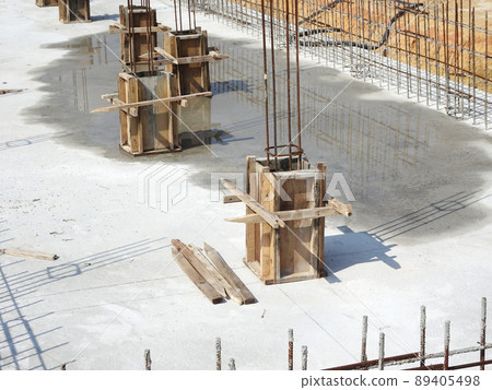 SELANGOR, MALAYSIA -JULY 7, 2021: Column stump formwork that has been installed at the construction site. Steel reinforcement bars are ready to be installed and ready to be poured concrete into it. SELANGOR, MALAYSIA -JULY 7, 2021: Column stump formwork that has been installed at the construction site. Steel reinforcement bars are ready to be installed and ready to be poured concrete into it. 89405498
