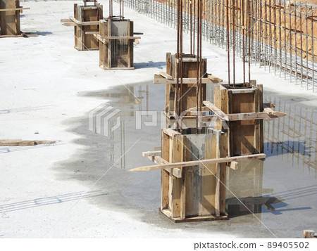 SELANGOR, MALAYSIA -JULY 7, 2021: Column stump formwork that has been installed at the construction site. Steel reinforcement bars are ready to be installed and ready to be poured concrete into it. SELANGOR, MALAYSIA -JULY 7, 2021: Column stump formwork that has been installed at the construction site. Steel reinforcement bars are ready to be installed and ready to be poured concrete into it. 89405502