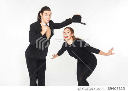 Two comedian circus artist posing and looking at camera. Studio shot, isolated on white background 89405813