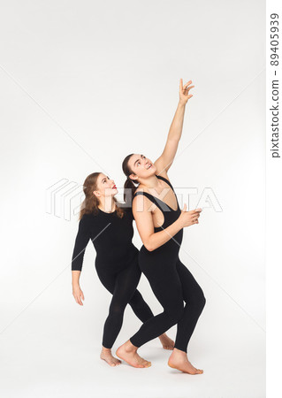 Happiness couple dreaming, looking up and toothy smile. Studio shot, isolated on white background 89405939