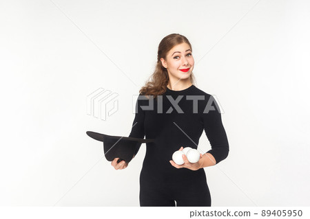 Happiness woman holding juggler balls and hat. Studio shot, isolated on white background 89405950