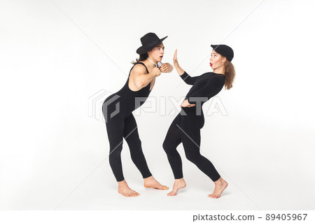 Hey you! Woman showing stop sign young man. Studio shot, isolated on white background 89405967