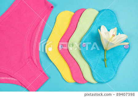 Bamboo charcoal washable sanitary napkins. Eco reusable menstrual pads and underpants on blue background. Women health concept, eco-friendly, zero waste alternatives Bamboo charcoal washable sanitary napkins. Eco reusable menstrual pads and underpants on blue background. Women health concept, eco-friendly, zero waste alternatives 89407398