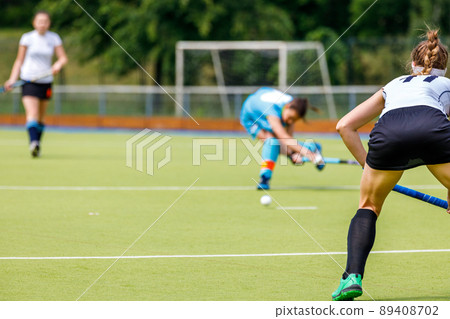 Young woman field hockey player in defense position on the game 89408702