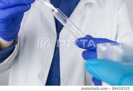 Medical laboratory assistant checks a test tube with sperm. Spermogram. Male fertility test. Semen in a test tube. Reproductive system check. Donor suitability test for artificial insemination 89410325
