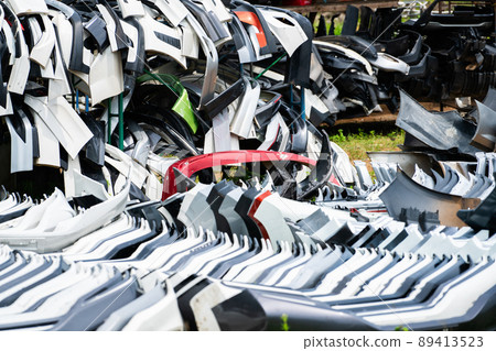 Pile of used front bumper, rear bumper, and spoiler of car for recycle. Carbon fiber, PU and PP plastic auto parts products. Automotive industry. Scrap yard of old bumper, spoiler. Plastic waste. Pile of used front bumper, rear bumper, and spoiler of car for recycle. Carbon fiber, PU and PP plastic auto parts products. Automotive industry. Scrap yard of old bumper, spoiler. Plastic waste. 89413523