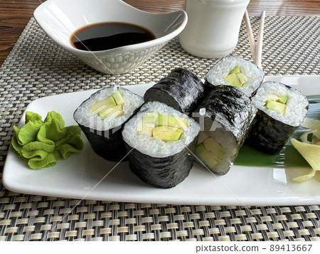 Mini rolls with avocado and soy sauce Mini rolls with avocado and soy sauce 89413667