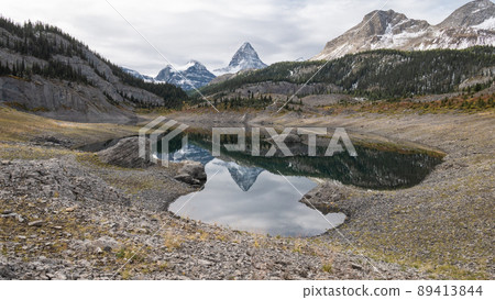 Prominent peak reflecting in the alpine lake in a small valley, Mt Assiniboine Pr. Park, Canada Prominent peak reflecting in the alpine lake in a small valley, Mt Assiniboine Pr. Park, Canada 89413844