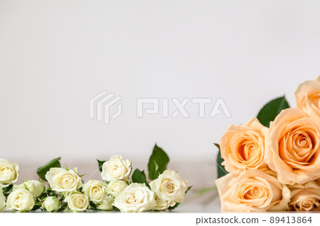 rose flowers and eucalyptus leaves on a white wooden background 89413864