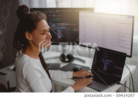 Close up portrait of young joyful woman coder works at home typing on laptop computer Close up portrait of young joyful woman coder works at home typing on laptop computer 89414267