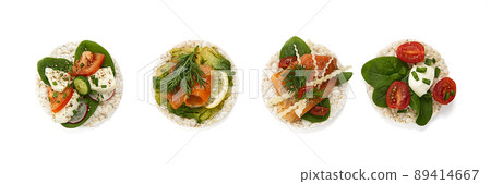 set of rice cakes on white background. healfy food rice cake sandwich isolated on white background. Rice cakes with Basil, tomatoes, avacado, cheese and red trout or salmon fish, mozerella chesse, 89414667