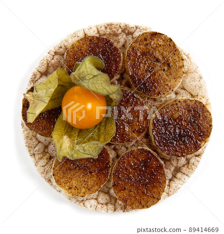 healfy food rice cake sandwich isolated on white background. Rice cakes with sliced banana powder sprinkled with cocoa powder and physalis healfy food rice cake sandwich isolated on white background. Rice cakes with sliced banana powder sprinkled with cocoa powder and physalis 89414669