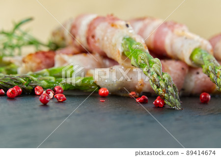 Asparagus with bacon served on black stone. healthy food - breakfast. dark food background. Asparagus with bacon served on black stone. healthy food - breakfast. dark food background. 89414674