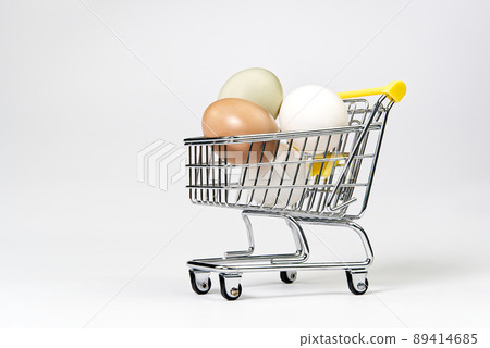 chicken colored eggs in a shopping cart. isolated on white chicken colored eggs in a shopping cart. isolated on white 89414685