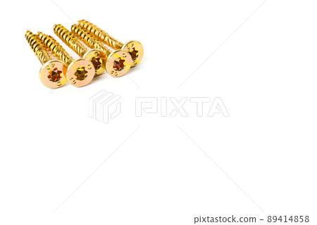 Gold screws scattered randomly on a white background. Torx yellow zinc head screws Gold screws scattered randomly on a white background. Torx yellow zinc head screws 89414858