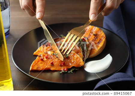 Concept of tasty eating with baked pumpkin 89415067