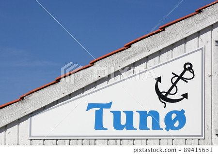 Tuno island sign in Denmark on a wooden wall Tuno island sign in Denmark on a wooden wall 89415631