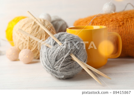 Concept of knitting with yarn balls on white wooden table, close up Concept of knitting with yarn balls on white wooden table, close up 89415867