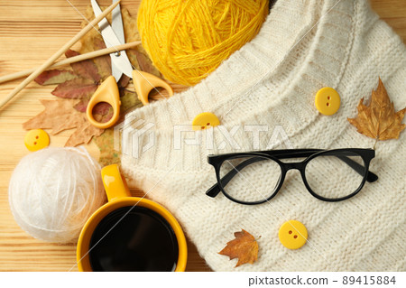 Concept of knitting with yarn balls on wooden table Concept of knitting with yarn balls on wooden table 89415884